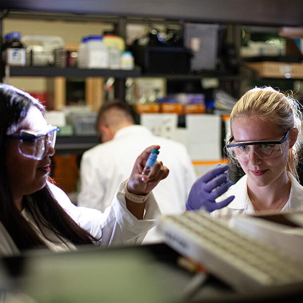 Two female students working in a chemical lab